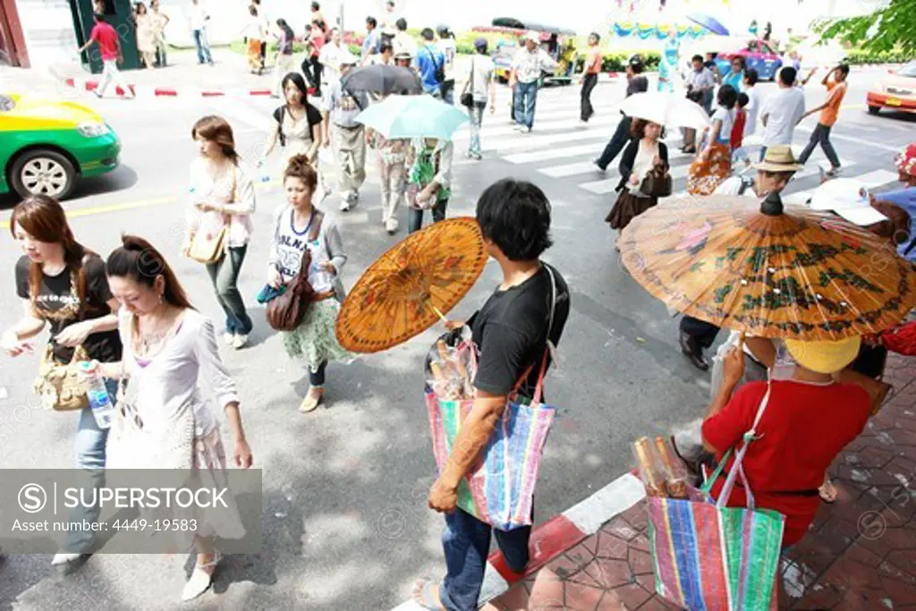 People walking on the street, selling umbrellas, Bangkok, Thailand, Asia