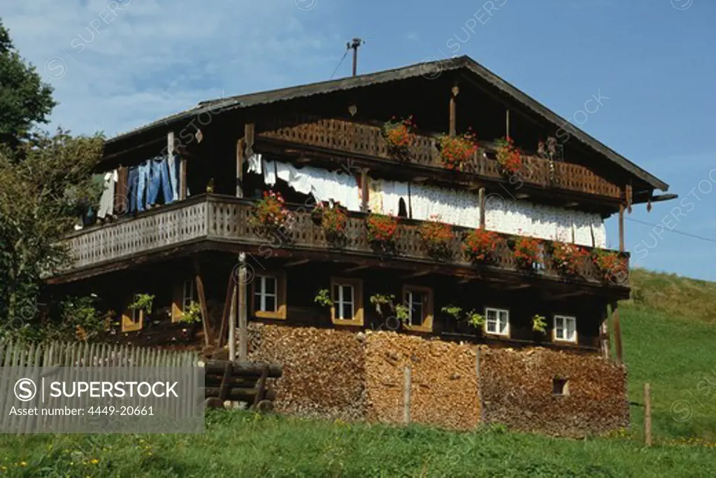 Laundry drying on a balcony of an old log-cabin style farm cottage, Bavarian Forest, Upper Palatinate, Bavaria, Germany
