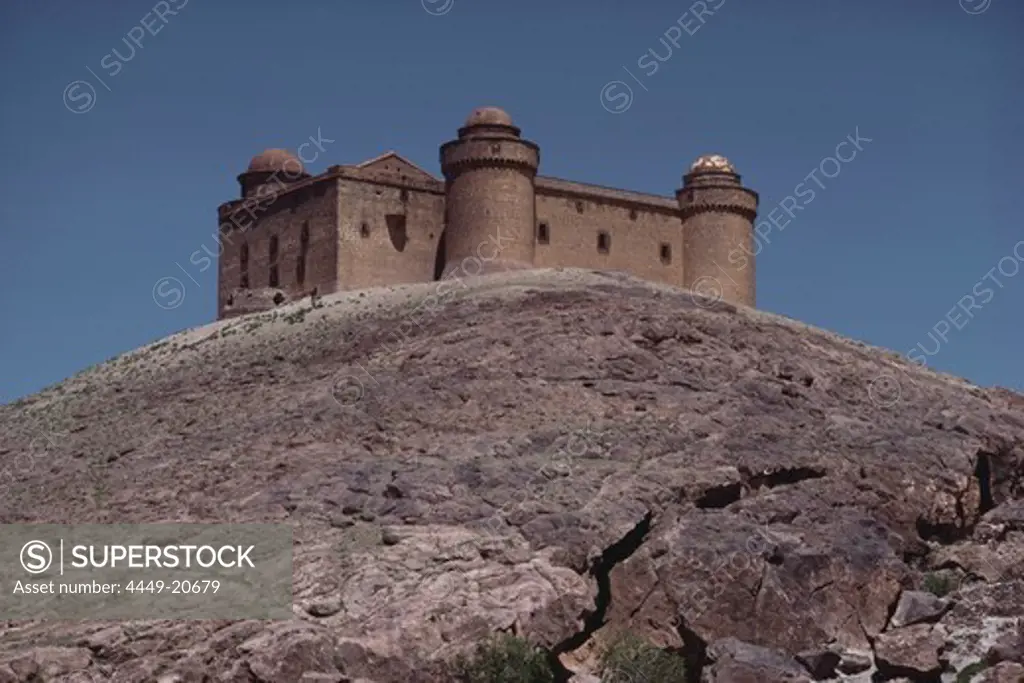 Renaissance castle of Lacalahorra on a smooth rocktop, Sierra Nevada, Granada province, Andalusia. Spain