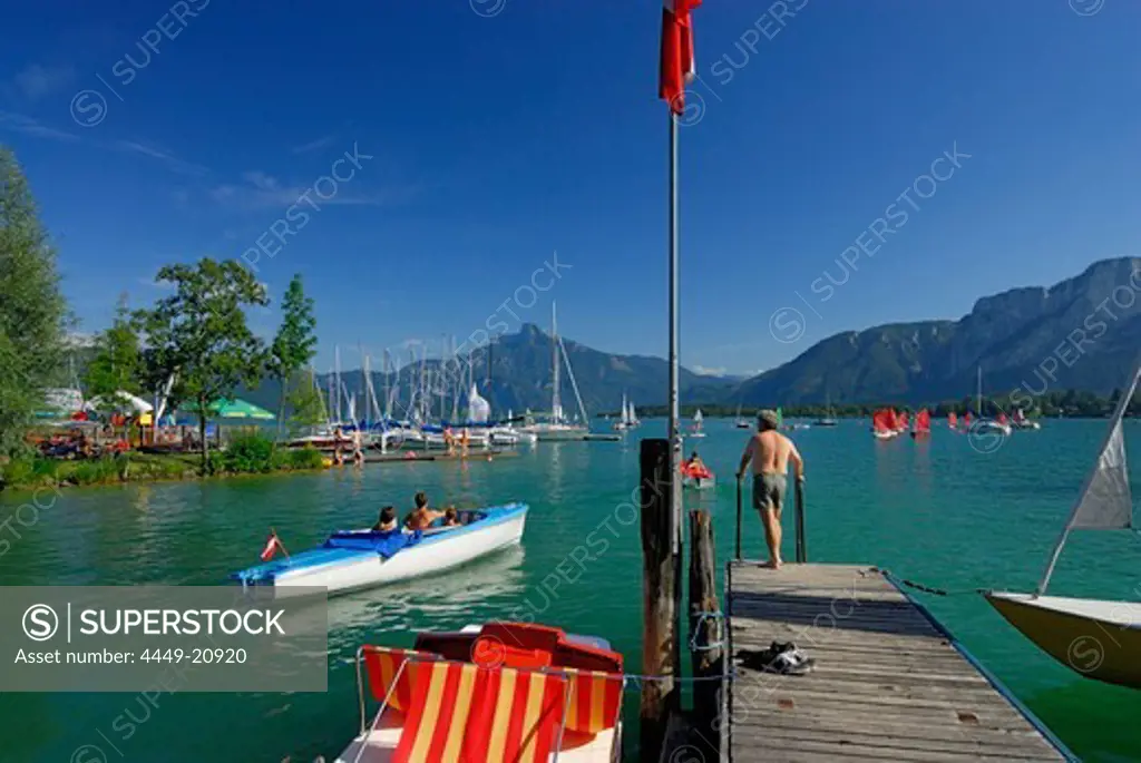 Landing stage at lake Mondsee, pedal boats and sailing boats, Salzkammergut, Salzburg, Austria