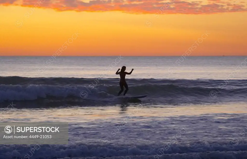 Evening with surf-riding woman at the beach of Carcans Plage, dept Gironde, France, Europe