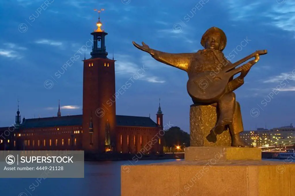 Sculpture of a musician on Riddarholmen and view onto the Stadshuset on Kungsholmen, Stockholm, Sweden