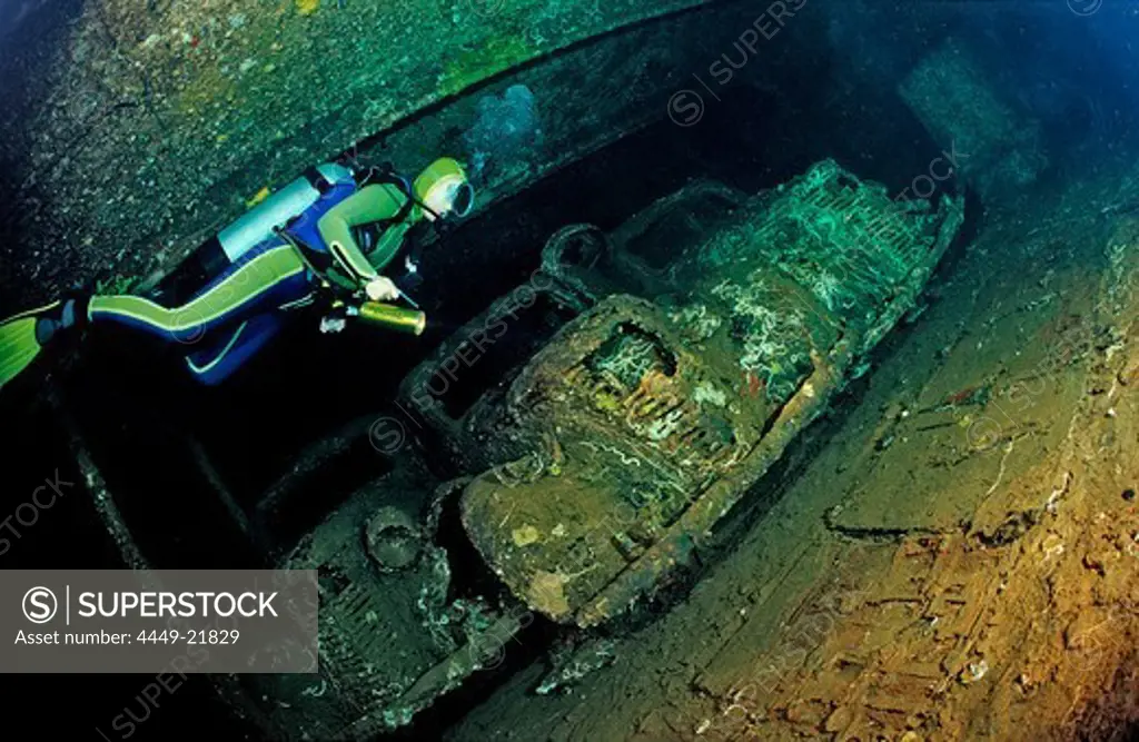 Scuba diver diving in the Umbria shipwreck, Military cars, Sudan, Africa, Red Sea, Wingate Reef