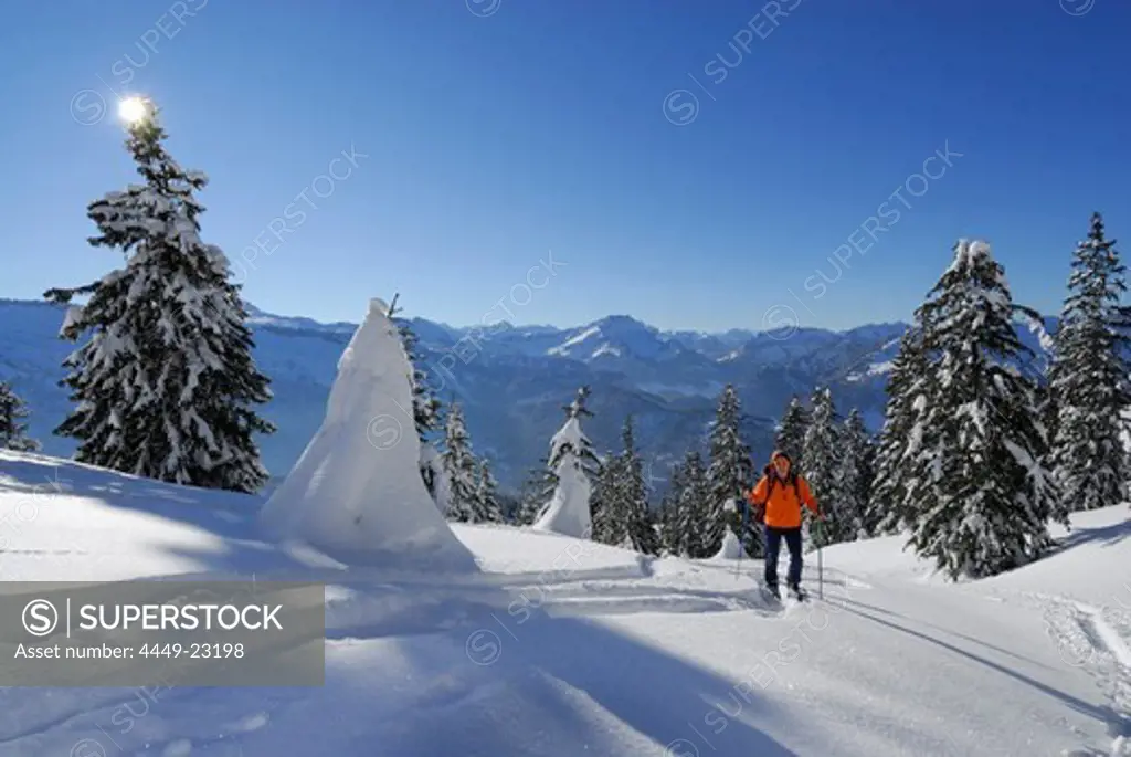 Backcountry skier in snow-covered mountain scene moving up, Feuerstaetter Kopf, valley of Balderschwang, Balderschwang, Allgaeu range, Allgaeu, Swabia, Bavaria, Germany