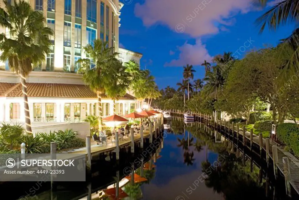 People sitting on the illuminated terrace of the Wild East Grill restaurant in the evening, Fort Lauderdale, Florida, USA