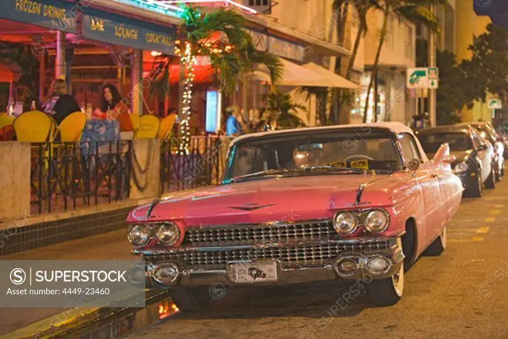 A vintage car on Collins Avenue in the evening, Miami Beach, Florida, USA