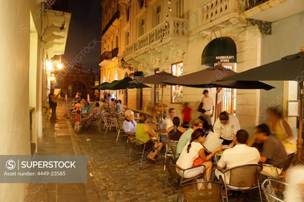 People sitting in front of a cafe at the Old Town in the evening, Calle de Christo, San Juan, Puerto Rico, Carribean, America