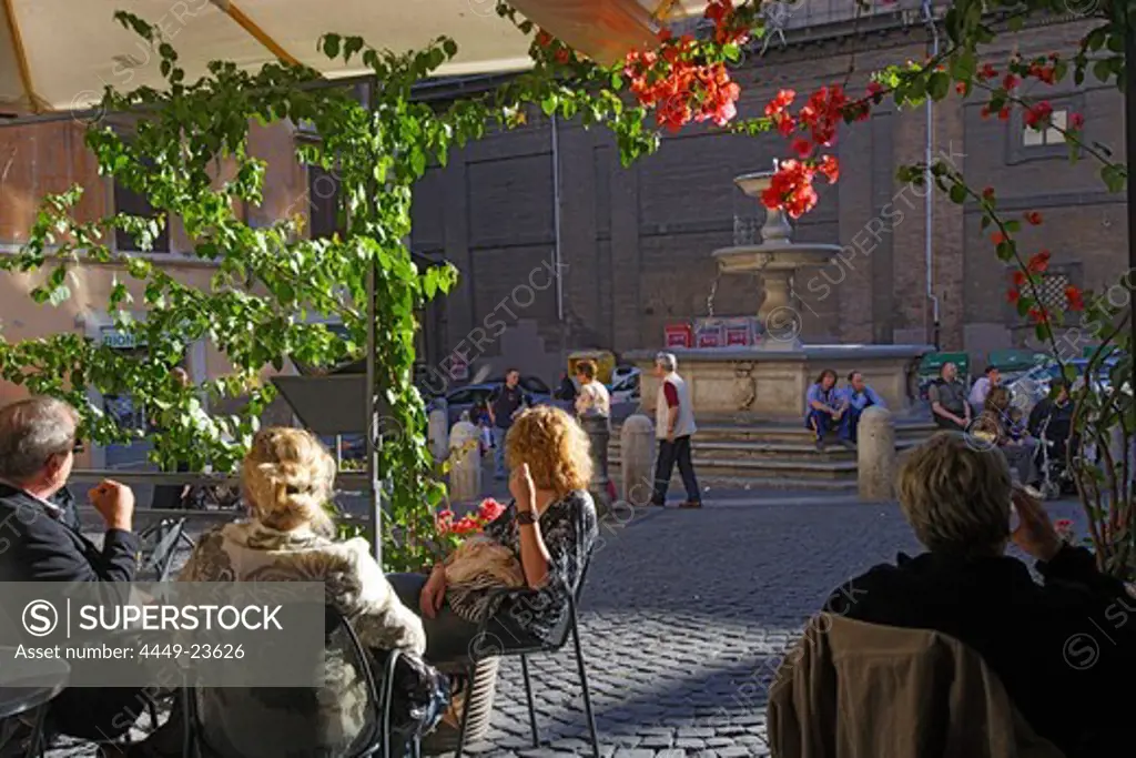 People sitting in front of a cafe in the sunlight, Via Cavour, Rome, Italy, Europe