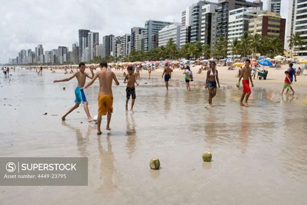 Boys playing beach soccer with coconut goal posts, Recife, Pernambuco, Brazil, South America