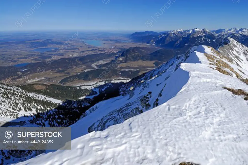 view from snow-covered summit of Grosse Schlicke to lake Weissensee, Hopfensee, Forggensee and Bannwaldsee, Tannheim range, Allgaeu range, Allgaeu, Tyrol, Austria