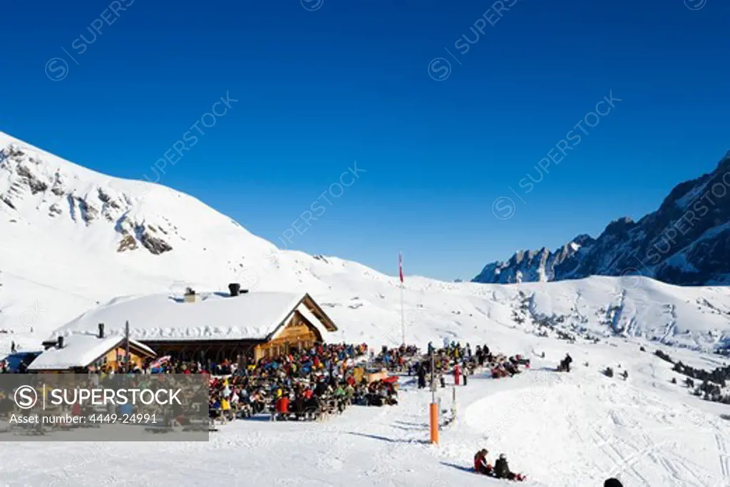 Skiers resting at mountain restaurant Schreckfeld, First, Grindelwald, Bernese Oberland, Canton of Bern, Switzerland