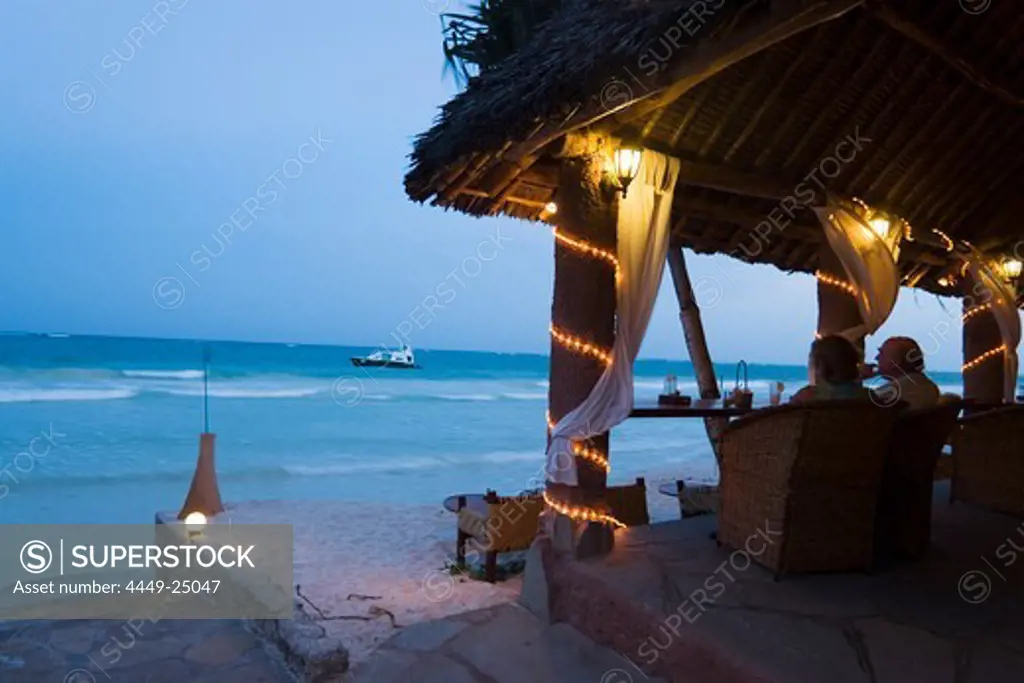 Couple sitting in a beach bar, The Sands, at Nomad, Diani Beach, Kenya