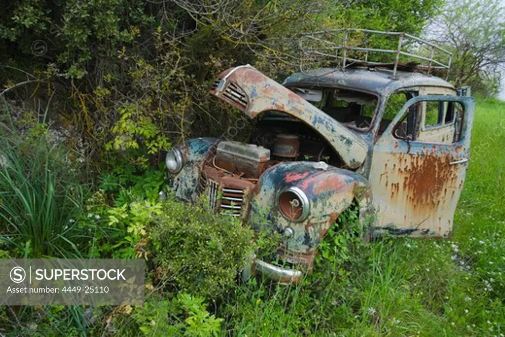 Old, derelict, wrecked car in a field, Troodos mountains, South Cyprus, Cyprus