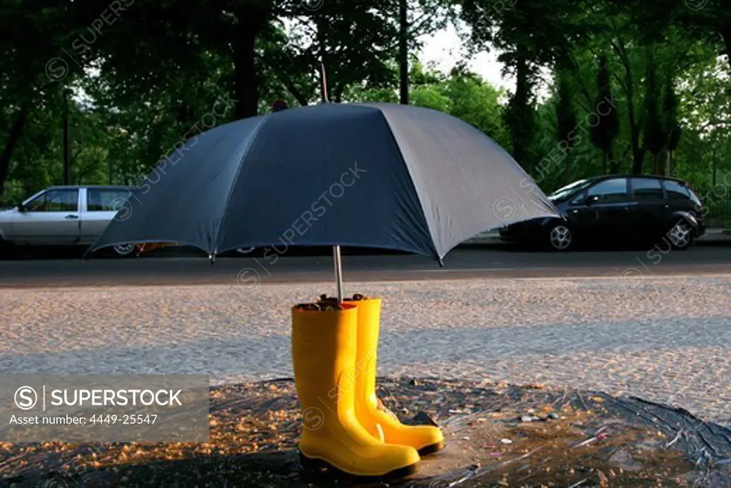 Street Art, an umbrella with wellington boots, Weather, Berlin, Germany
