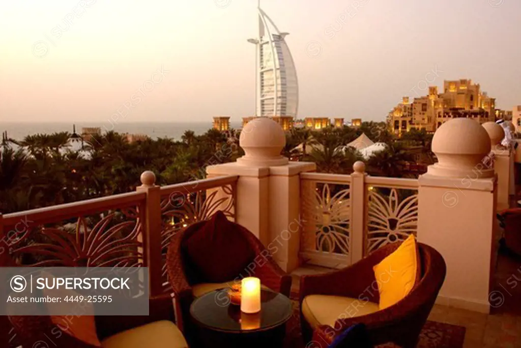 Outdoor Seating at restaurant terrace at dusk, Al Qasr hotel, View at Burj Al Arab Hotel, Madinat Jumeirah, Dubai, United Arab Emirates, UAE