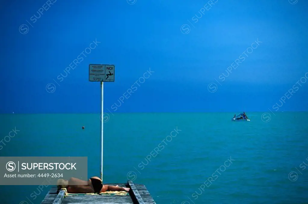 A person on a jetty on the waterfront, Lido di Jesolo, Veneto, Italy, Europe