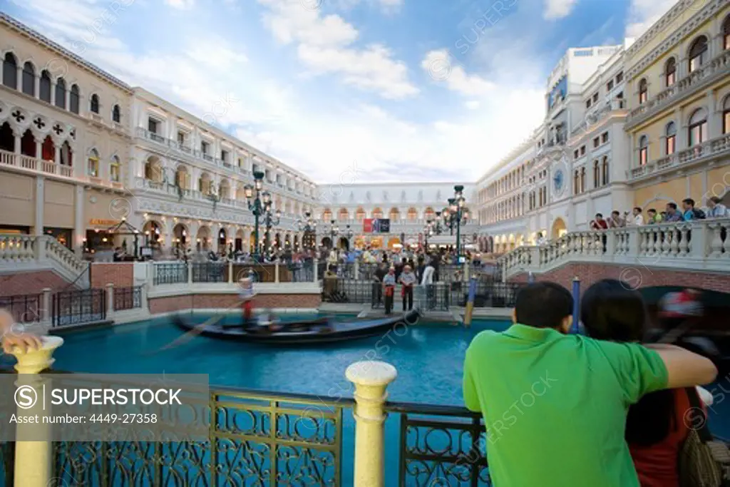 Couple watching the gondoliers on the Grand Canal at the Venetian Hotel in Las Vegas, Nevada, USA