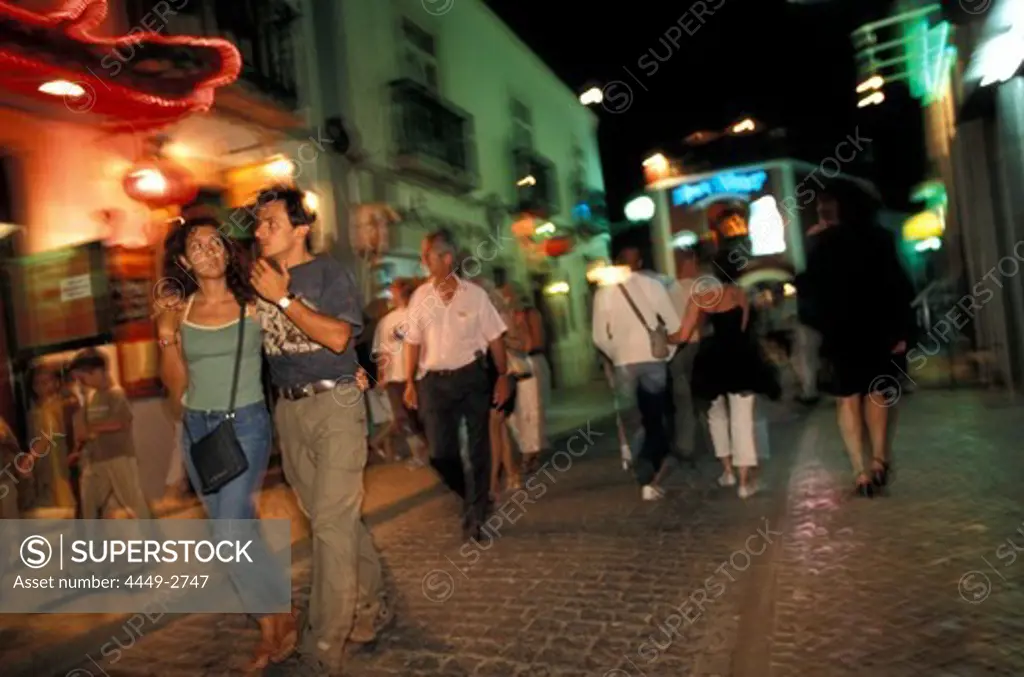People at pedestrian area at night, Lagos, Algarve, Portugal, Europe