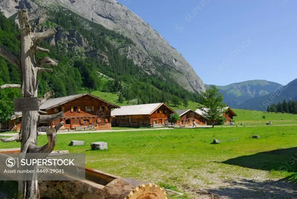 fountain with alpine huts of Enger Alm, Eng, Karwendel range, Tyrol, Austria