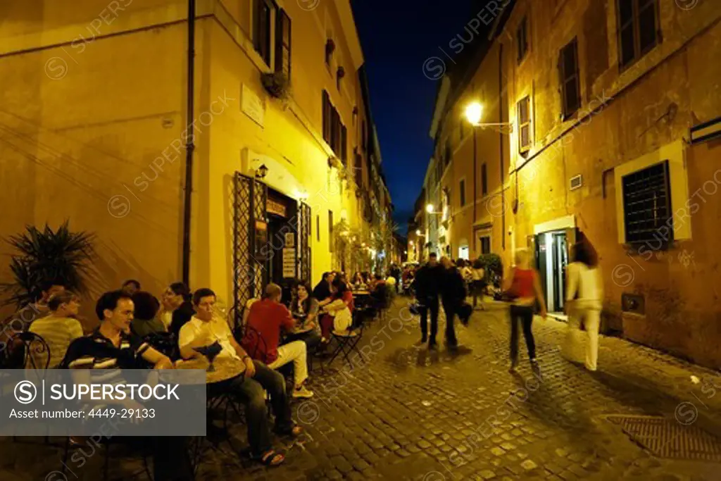 Restaurants and pavement cafes along cobblestone land, Trastevere, Rome, Italy
