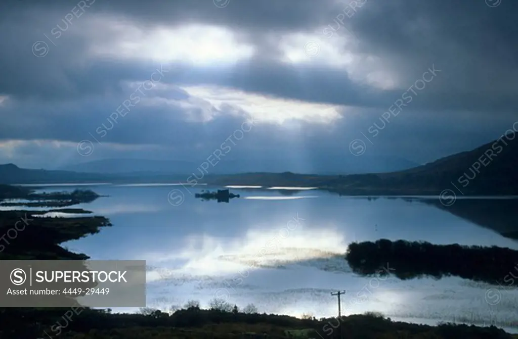 Cloud cover and sigle sunbeams over the Lough Corrib, Connemara, County Galway, Ireland, Europe