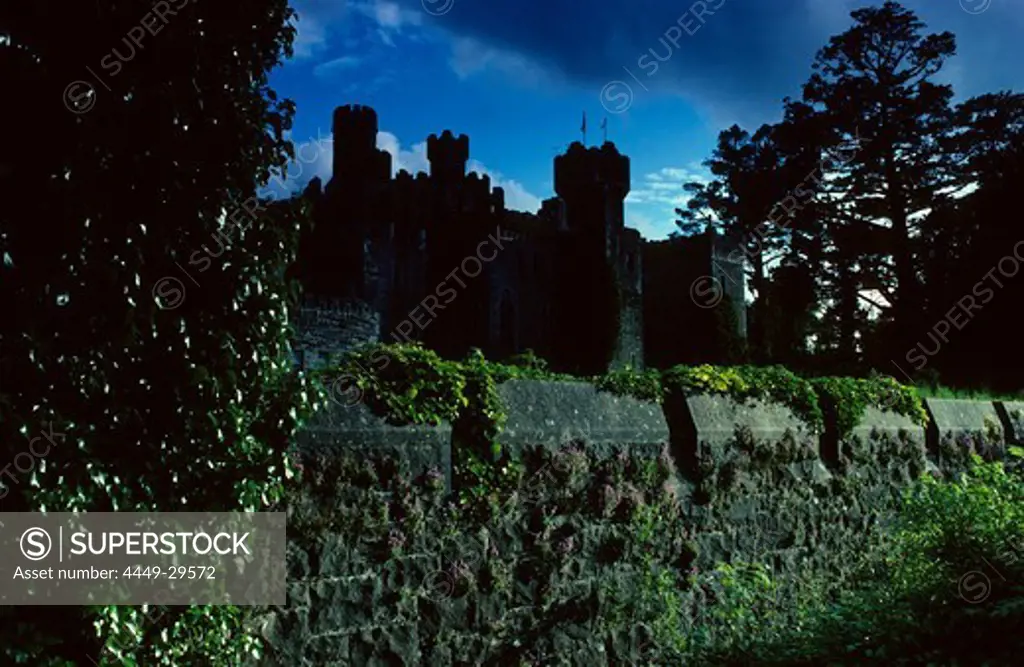 View at the silhouette of Ashford Castle under dark clouds, County Mayo, Ireland, Europe