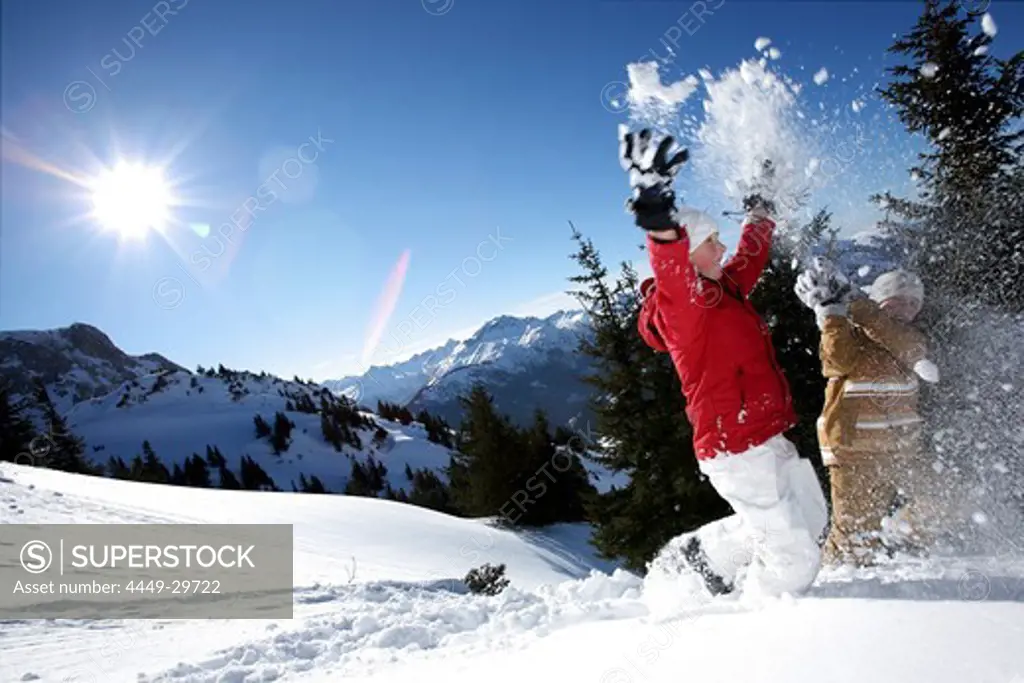 children throwing snow in the air, See, Tyrol, Austria