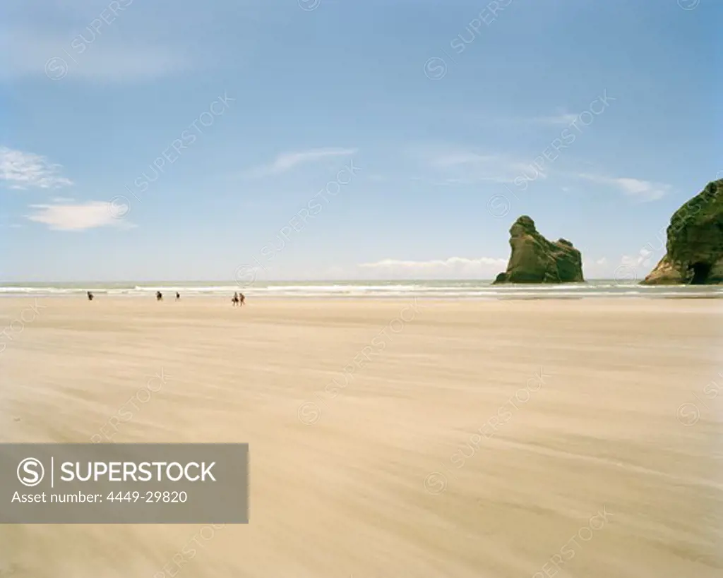 Sandy beach at lowtide in front of rock islands, Wharariki Beach, northwest coast, South Island, New Zealand