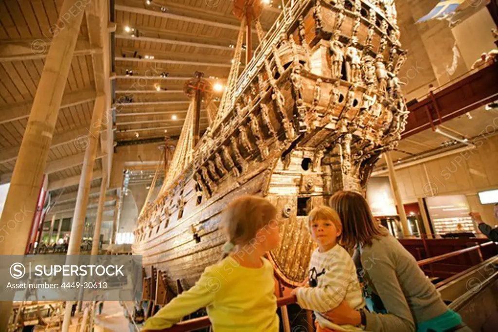 Mother and two children looking at a Vasa Schiff in the Vasa museum, Stockholm, Sweden