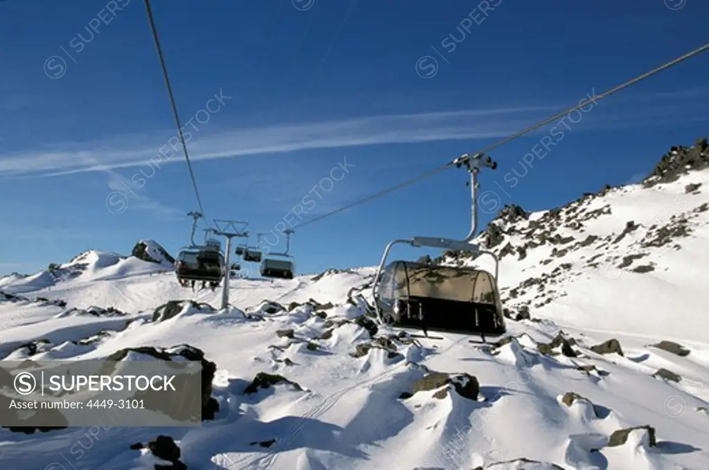 Chair lift in front of snowy mountainside, Ischgl, Samnaun, Tyrol, Austria, Europe