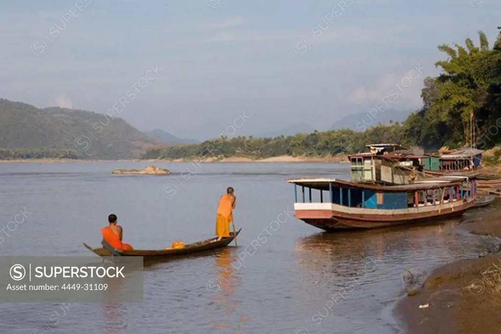 Two young buddhistic monks in a boat on the river Mekong, Luang Prabang, Laos
