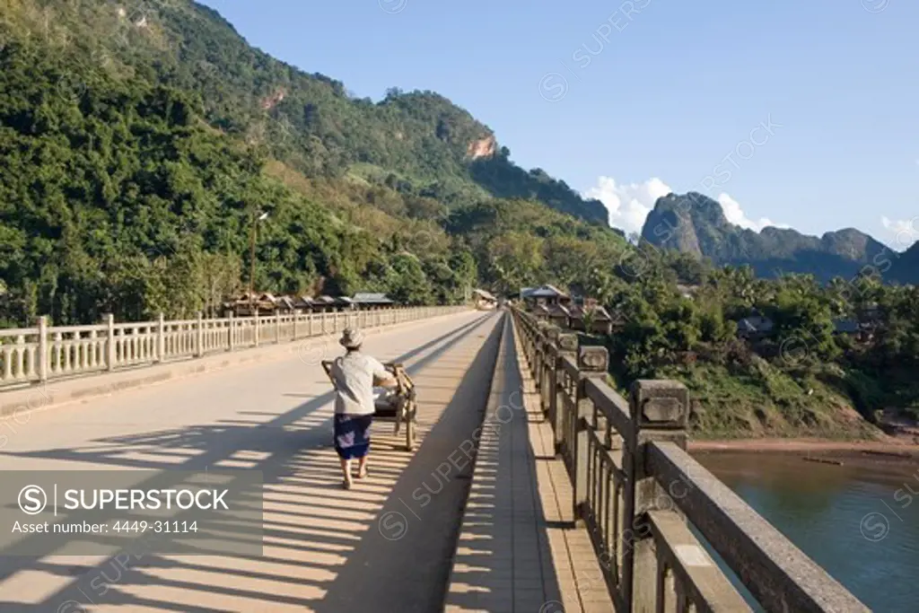 A person on the bridge over the river Nam Ou at the village Nong Kiao, Luang Prabang Province, Laos