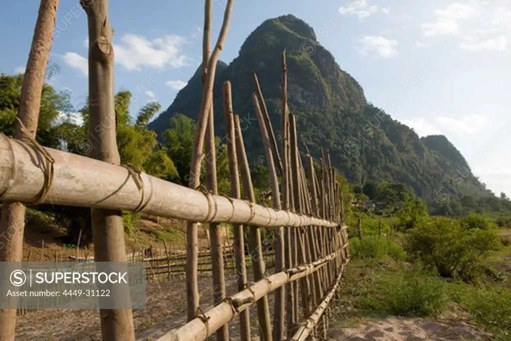 Wooden fence at the fishing village Muang Ngoi Kao in the sunlight, Luang Prabang province, Laos
