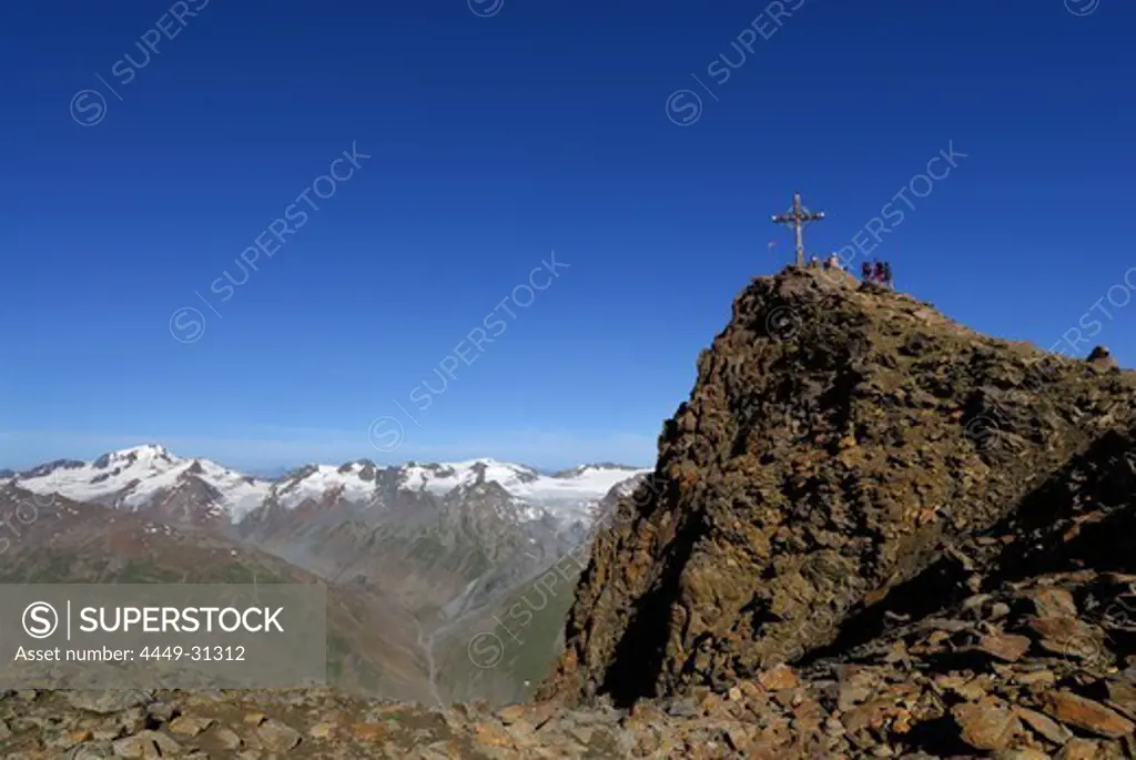 group of hikers on summit of Kreuzspitze, Weisskugel in background, Oetztal range, Tyrol, Austria