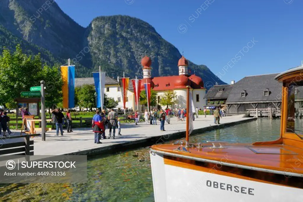 people walking on pier, with boat, St. Bartholomae, lake Koenigssee, Berchtesgaden range, National Park Berchtesgaden, Berchtesgaden, Upper Bavaria, Bavaria, Germany