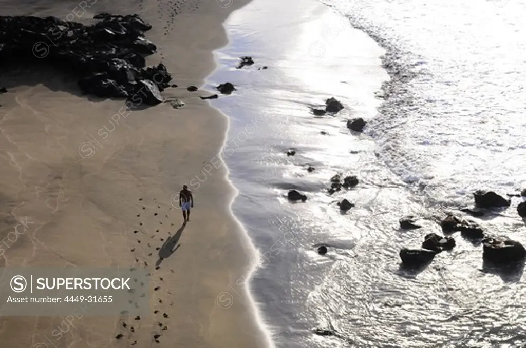 Person walking along the beach, Sao Roque near Ponta Delgada, Sao Miguel, Azores, Portugal