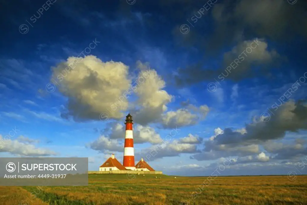 Westerhever lighthouse under cloudy sky, Eiderstedt peninsula, North Friesland, Schleswig-Holstein, Germany