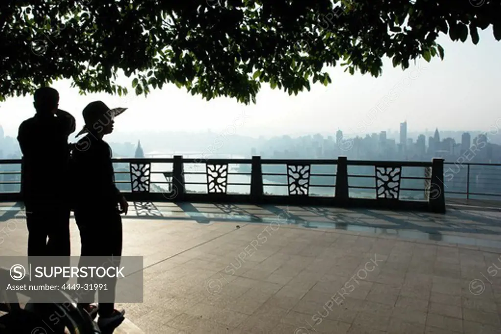A couple is enjoying the view to the skyline in Chongqing, China, Asia