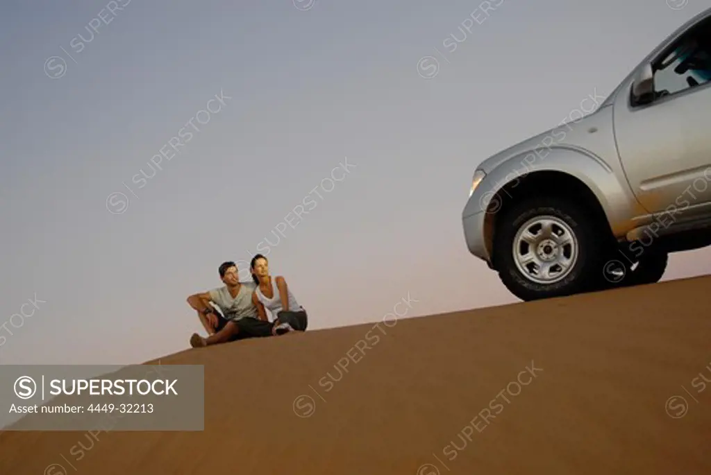 People and detail of an all-terrain vehicle on a dune, Wahiba Sands, Oman, Asia