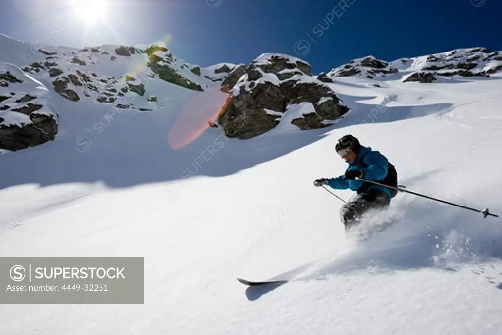 Domaine de Freeride, Zinal, A young man with telemark skis makes big turns in powder snow, canton Valais, Wallis, Switzerland, Alps, MR