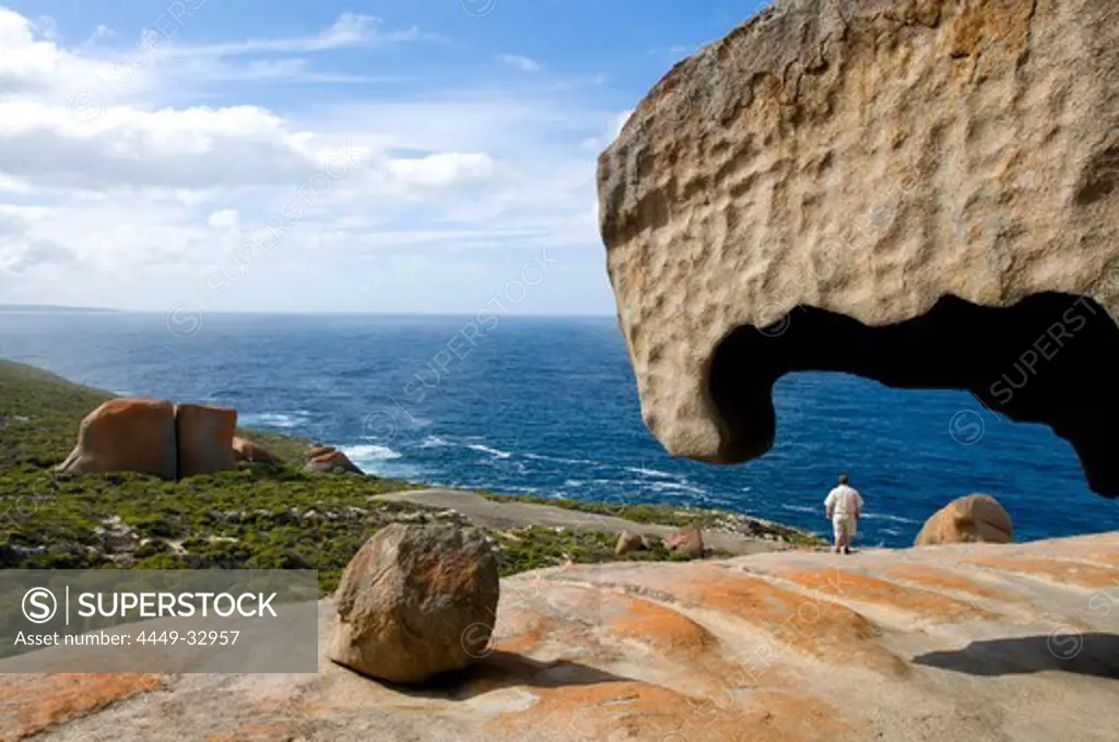 A man standing amidst the Remarkable Rocks at Flinders Chase National Park at the coast, Kangaroo Island, South Australia, Australia