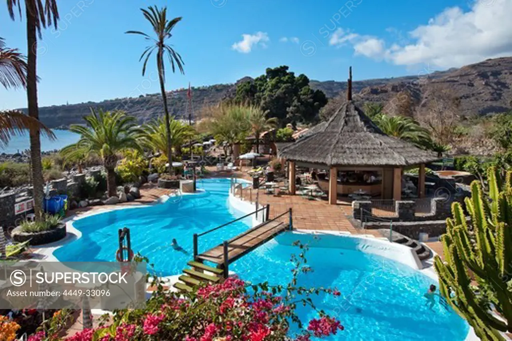 View over the swimming pool of Jardin Tecina Hotel in the sunlight, Playa de Santiago, La Gomera, Canary Islands, Spain, Europe