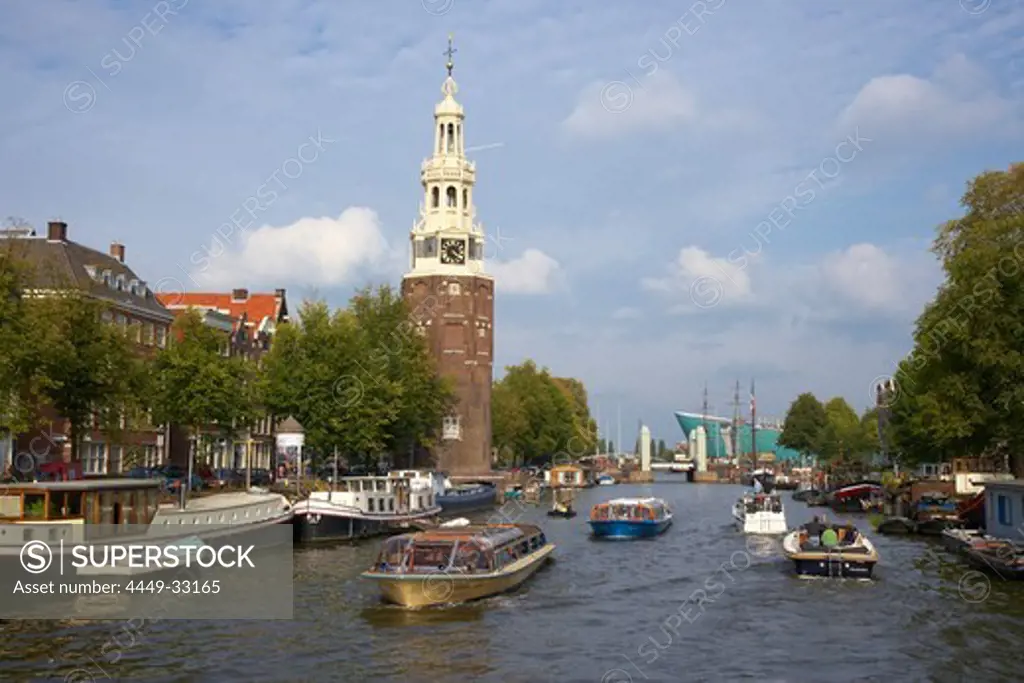 Boats driving on the river Oude Schans at Amsterdam, Netherlands, Europe