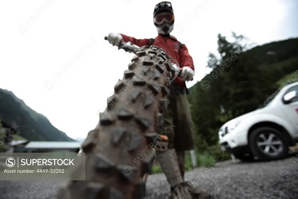Man holding his mountainbike, Ischgl, Tyrol, Austria