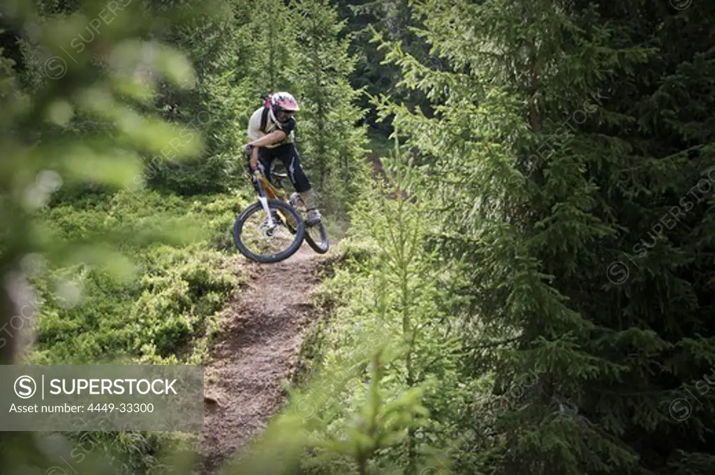 Mountainbiker jumping on a trail in the forest, Lillehammer, Norway