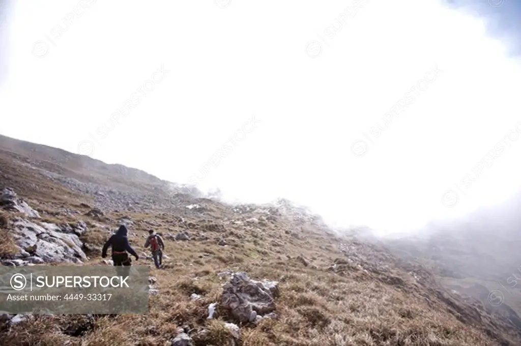 Two people hiking through a mountain scenery, Oberstdorf, Bavaria, Germany