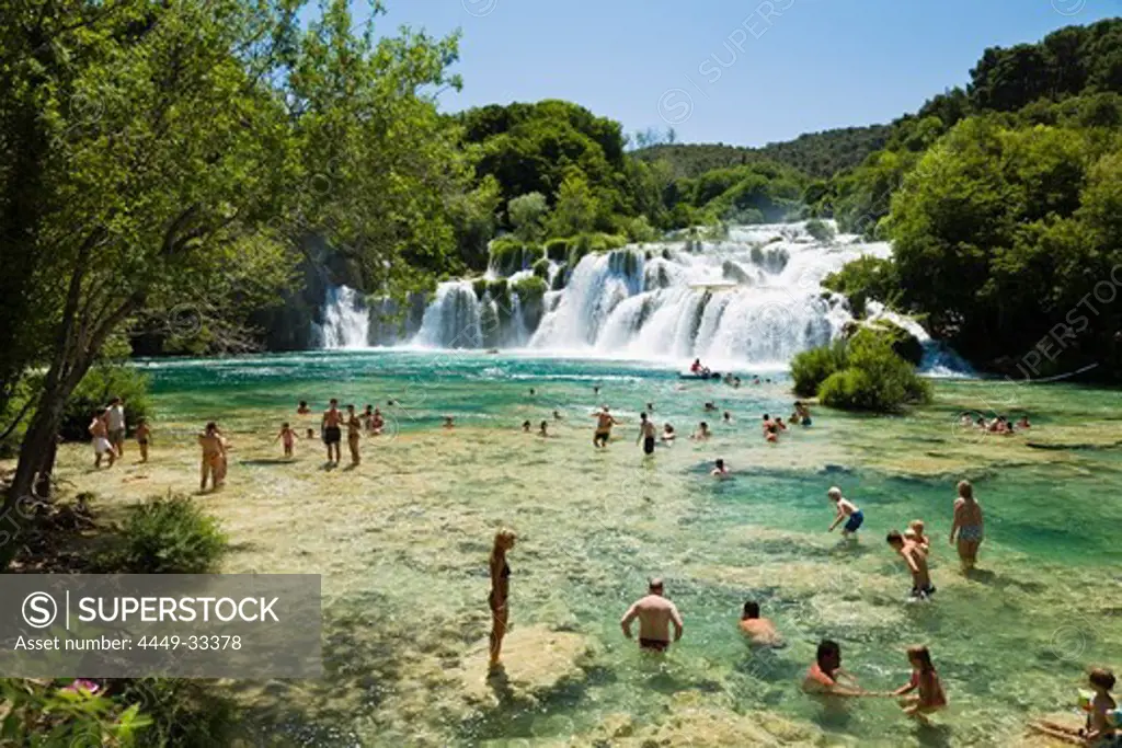 People bathing in the river at Krka waterfalls, Krka National Park, Dalmatia, Croatia, Europe