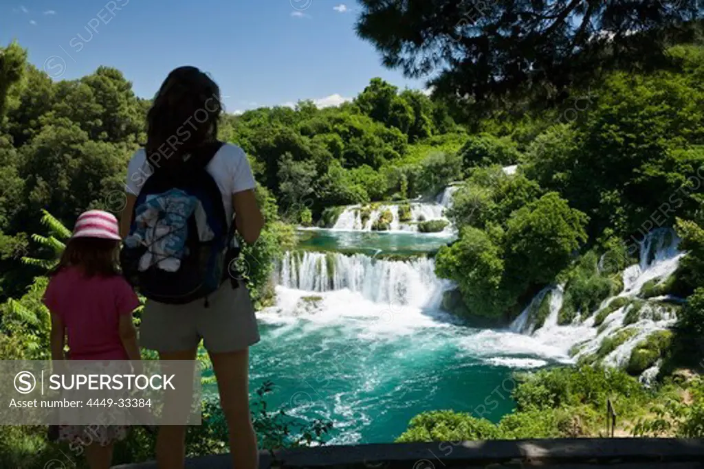 A woman and a child looking at the Krka waterfalls, Krka National Park, Dalmatia, Croatia, Europe