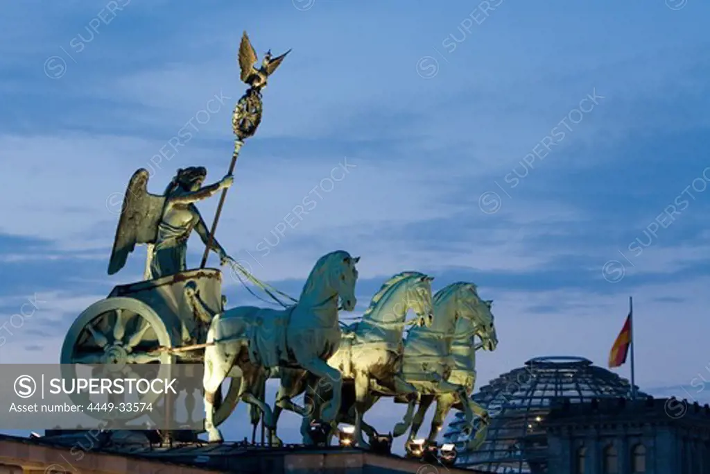 Quadriga, horse and chariot sculpture on Brandenburg Gate, in the background the Reichstag, Berlin