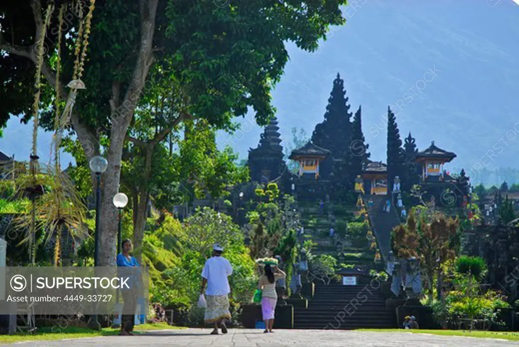People on a street, in the background Besakih, the balinese main temple, Bali, Indonesia, Asia